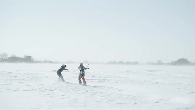 People ride on winter snowkiting.Winter snowkiting on the winter field after snow storm in Odessa Ukraine