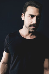 Fototapeta premium Young handsome man with beard and mustache studio portrait