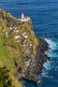 Dramatic view down to lighthouse on Ponta do Arnel, Nordeste, Sao Miguel Island, Azores, Portugal