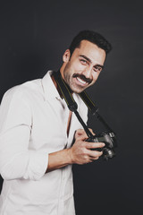 Young handsome photographer with beard and mustache studio portrait