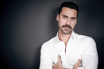 Young handsome man with beard and mustache studio portrait