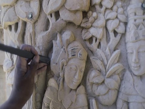 Balanese man making wooden sculpture for tourists in Ubut. Wood Carving is a traditional handicraft in Indonesia