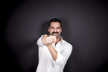 Young man showing figa mudra
