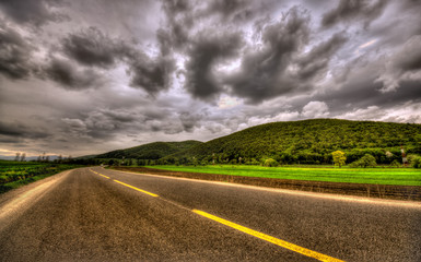 dark scene with overcast clouds and road