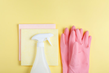 flat laying, tools for harvesting on a yellow background, swipe to dust, pink gloves, sprayer