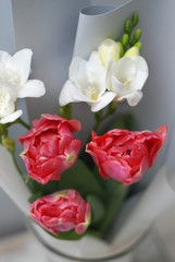 Beautiful bouquet of pink tulips and Freisia Flowers on wooden background. Spring bouquet for Gift with Copy Space.