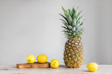 pinneapple and lemons on white background