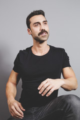Handsome man with beard and mustache studio portrait