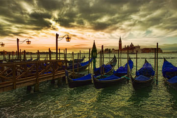 Fototapeta na wymiar dramatic view of Venice city gondola at sunset