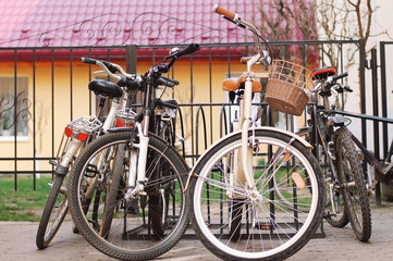 City and mountain bikes are parked in a bicycle parking lot in the city