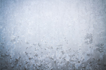 Winter frosty patterns on the frozen ice window