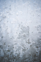 Winter frosty patterns on the frozen ice window