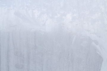 Winter frosty patterns on the frozen ice window