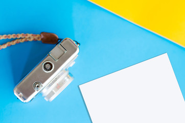 Top view of vintage camera on two color blue and yellow background,