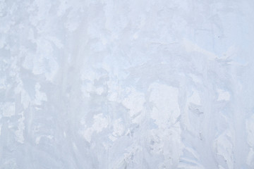 Winter frosty patterns on the frozen ice window