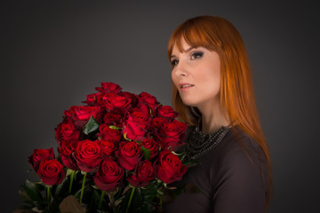 Young woman with ginger hair on international womens day with a lot of flowers