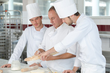 apprentice in bakery learning with professor