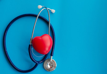 Top view blue stethoscope on blue background. health background