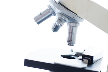 Close-up shot of microscope with metal lens at laboratory. Scientific and healthcare research background.