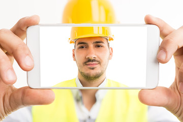 Constructor or builder taking a selfie with smartphone.