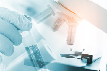 Fototapeta premium Scientific and healthcare research background. scientist hold blood tube for test