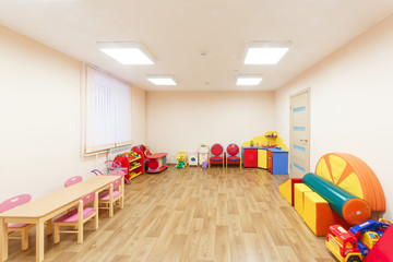 Spacious light pink colored game room with in the kindergarten