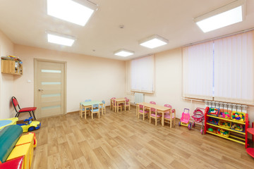 Spacious light pink colored game room with in the kindergarten