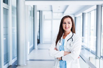 Optimistic female doctor standing indoor