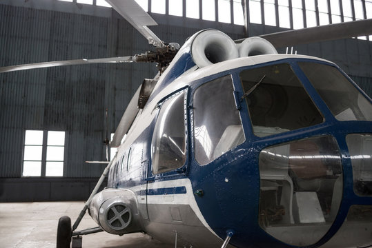Two-turbine helicopter in the hangar.