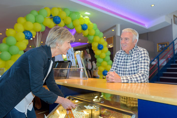 Man buying popcorn in cinema © auremar