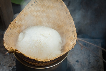 The Laotian Sticky rice (called “khao niaow”) is patiently being steamed before its deliciousness can be released. At the living land farm in Luang Prabang, Laos.