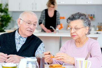 elderly couple having a meal