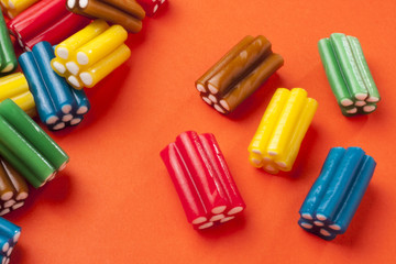 Colorful candy on orange background