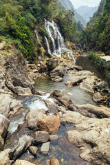 Waterfall with river flow with rocks at Cat Cat Village in summer in Sa Pa, Vietnam.