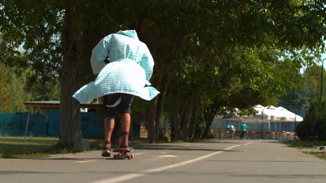 Skateboarding in a bath robe, slow motion