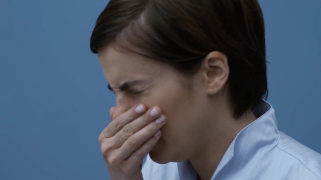 Woman sneezing and having a cold