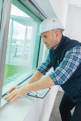 male window fitter working indoors