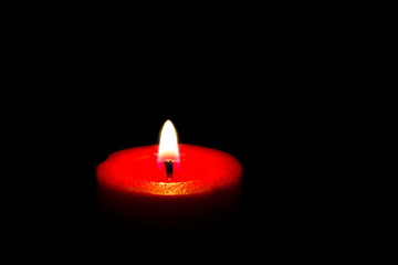 red candle on black background