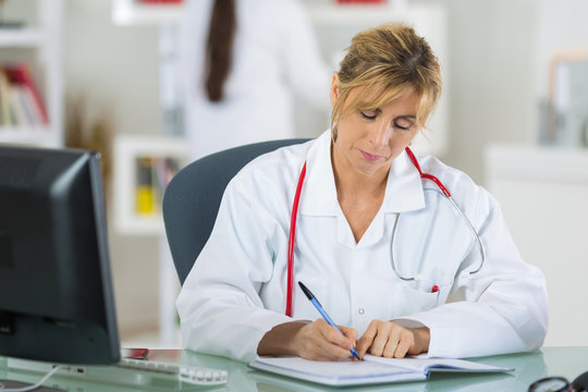 thoughtful female doctor holding a file