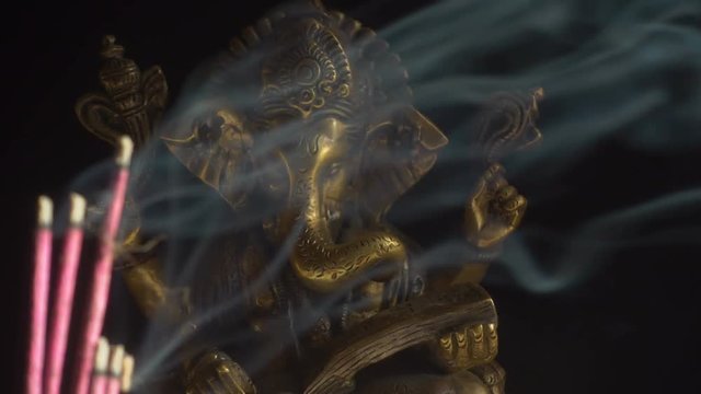 Hindu God Ganesha and smoking incense sticks - seamless loop