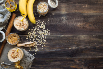 Nutritional smoothie with banana, oat flakes and peanut butter - obrazy, fototapety, plakaty