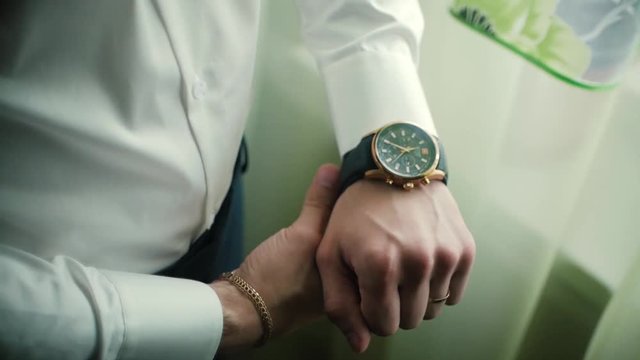 Closeup designer watch on businessman hand. Clip. Hand of businessman with a clock