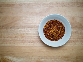 Overheard shot of porcelain bowl filled with red pepper flakes