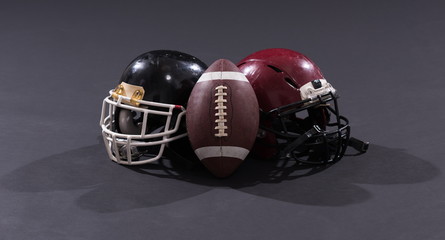 american football and helmets isolated on gray