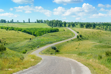 Winding road among fields in countryside.