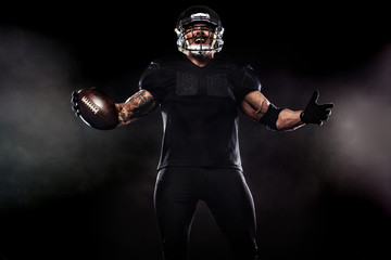 American football sportsman player isolated on black background
