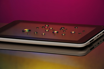 Drops of water on the smartphone screen. A saturated bright colored background. Copy space.