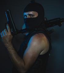 hit man, armed and dangerous man with balaclava and bulletproof vest, concept killer contract