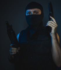 Bodyguard, hit man, armed and dangerous man with balaclava and bulletproof vest, concept killer...