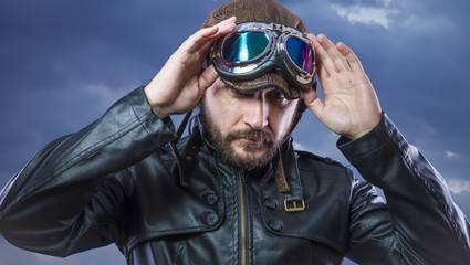 Rider, old motor driver, man with sunglasses leather jacket with expressive faces on storm clouds background